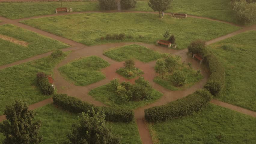 Aerial view of a serene park with pathways and lush greenery, perfect for leisure and relaxation