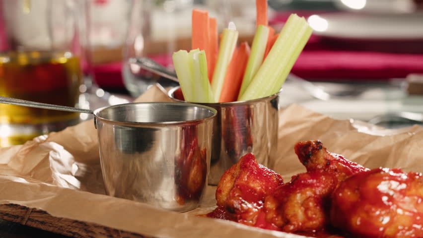 Crispy fried chicken wings cooking pieces sizzling in hot oil inside a deep fryer in a Restaurant, delicious cooking in a restaurant kitchen.