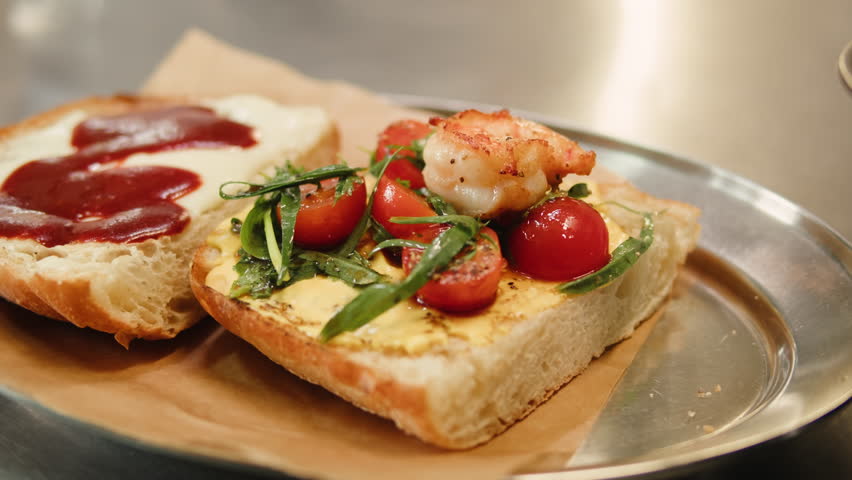 Fish sandwich foccacia with prawns, delicious homemade spicy shrimp sandwich with lettuce, tomato, and tartar sauce.
