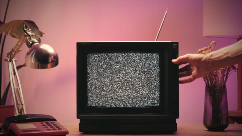 Retro TV, vintage television In a nostalgic setup, a retro TV displays grain on screen, scary halloween night device good for chroma key and green screen.