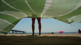 Man Tourist Enjoying a Relaxing Day at the Beach, Comfortably Seated Under a Bright Umbrella, Barcelona, spain. - Powered by Shutterstock - Get 15% off with code: PIKWIZARD15