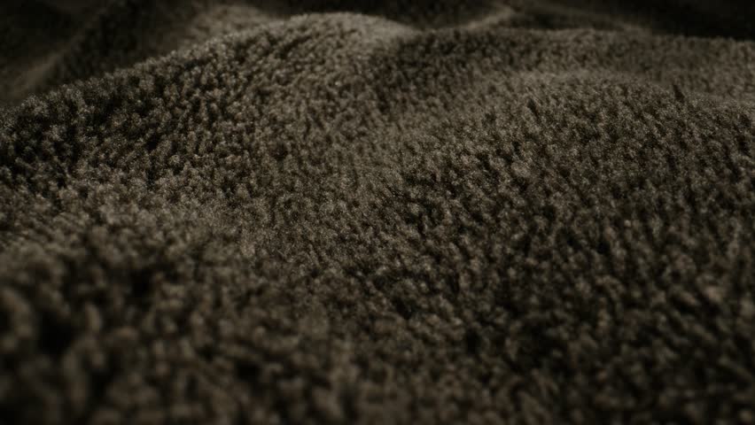 Beige wool background, natural sheepskin close-up macro coat. Top view