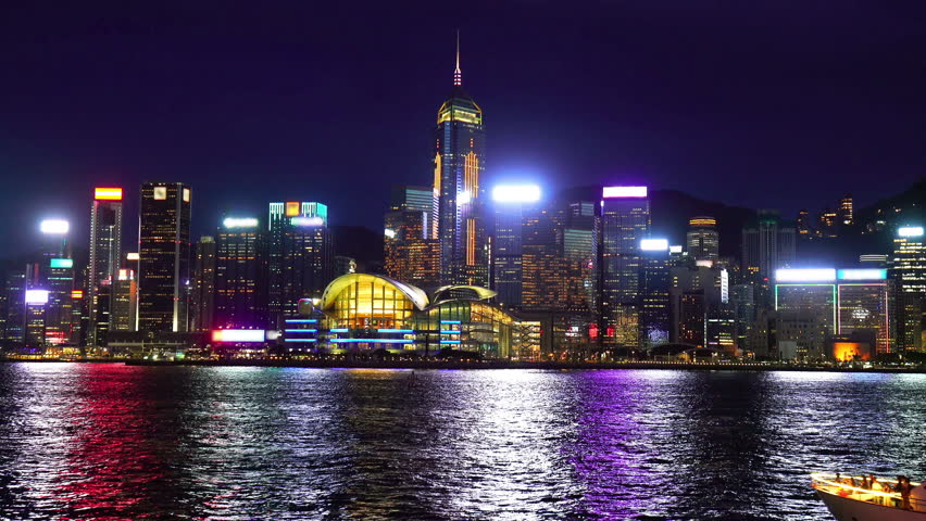 Footage of Skyscrapers and floating ship at Victoria's harbor, Hong Kong at night