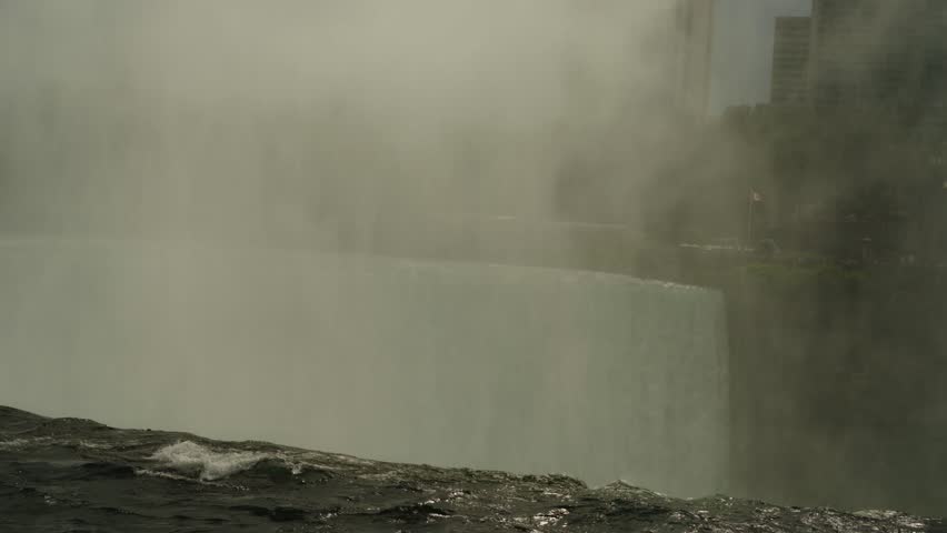 Thick mist rises from the powerful Horseshoe Falls, capturing the awe-inspiring force of Niagara on a cloudy day.