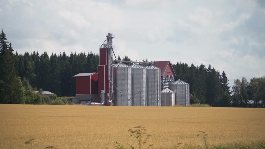 Grain silos and industrial building on a yellow field in Finland