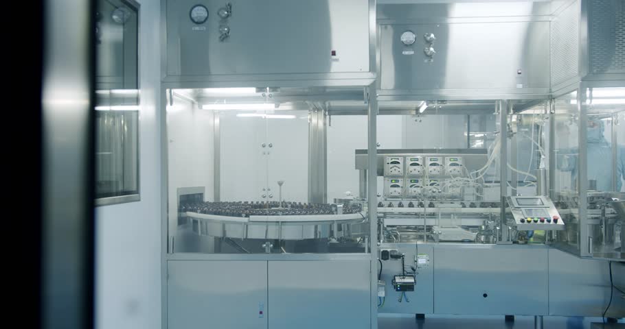 Sterile Pharmaceutical Manufacturing Laboratory where Scientists in Protective Coveralls. Factory Cleanroom. Pharmaceutical, Scientists in Sterile Protective Clothing Work on a Modern Laboratory.