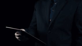 A businessman stands holding a tablet with an array of programming languages and code snippets displayed in a futuristic digital interface, symbolizing technology and innovation. Qubit - Powered by Shutterstock - Get 15% off with code: PIKWIZARD15