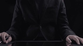 A professional analyzing data on a digital tablet featuring futuristic graphics and data visualization, representing modern technology in a workspace setting. Qubit - Powered by Shutterstock - Get 15% off with code: PIKWIZARD15