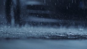Slow motion rain droplets explode into puddles on asphalt parking surface - Powered by Shutterstock - Get 15% off with code: PIKWIZARD15