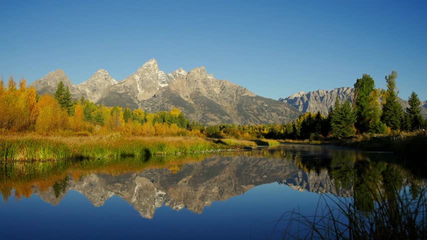 River view of Grand Teton National Park, Wyoming with yellow fall colors.