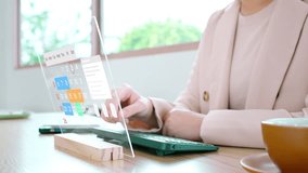 Close-up of a businesswoman's hand scheduling an appointment on a futuristic augmented reality calendar, managing time and booking events on a transparent touchscreen interface. - Powered by Shutterstock - Get 15% off with code: PIKWIZARD15