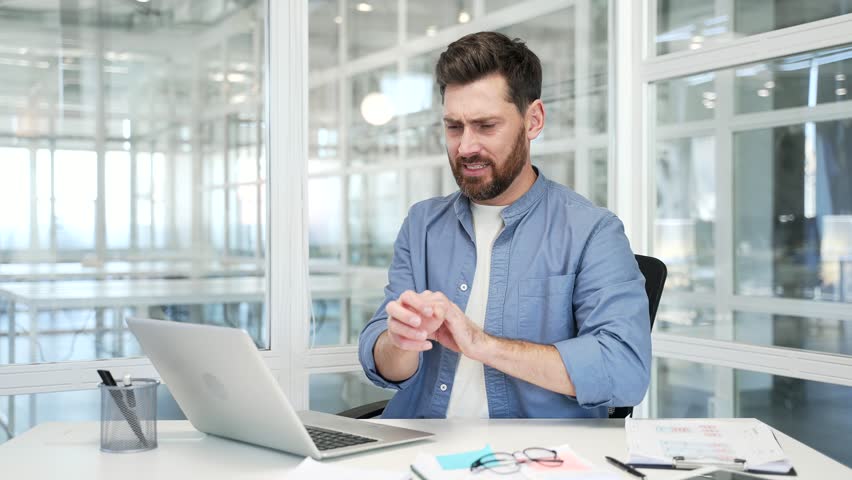 Allergy attack. Itch or pruritus. Businessman scratching suffering from allergic reaction or mosquito bite while sitting in business office. Man has scabies or as a result of stress scratches the body