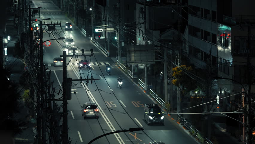 Night Traffic on Tokyo Street with Cars and Motorcycles