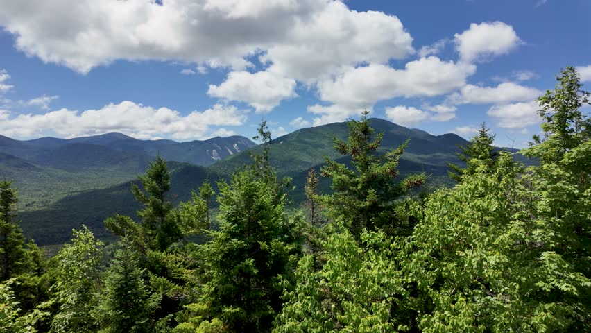 Panning view from atop Mt.Jo in the Adirondack Mountains showing some of the High Peaks on a beautiful summer day.