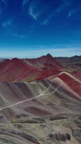 A vertical aerial footage of Rainbow Mountain, also known as Vinicunca in the Peruvian Andes, located in the Cusco region