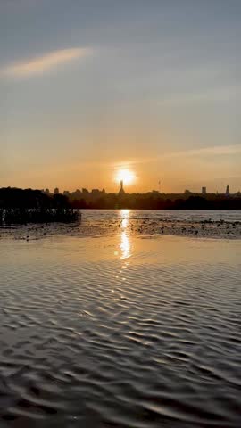 video sunset on the banks of the Dnipro River, view of Kyiv