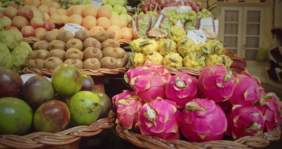 Bright pink dragon fruits and tropical produce on display at Madeira Lavradores Market, Portugal
