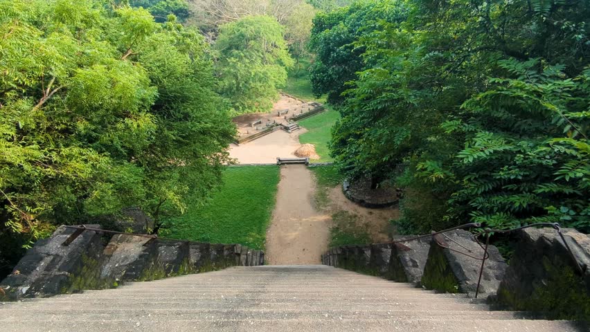 View from top of steep stone stairway steps of ancient Yapahuwa Rock Fortress palace in Sri Lanka