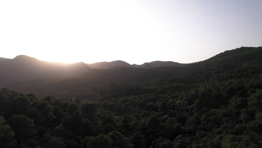 Sierra de Huetor natural park during sunset, drone flying backwards, Granada, Spain