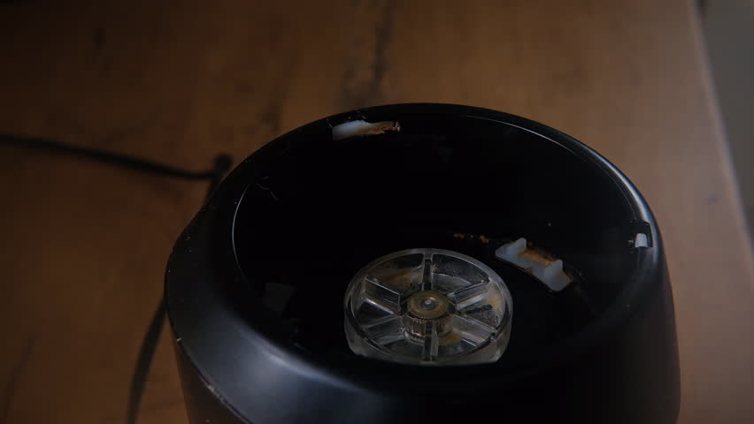 Strawberry banana smoothie placed onto mix blender base, close-up