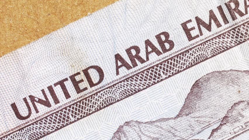 Macro pan revealing United Arab Emirates Central Bank text on a dirham note