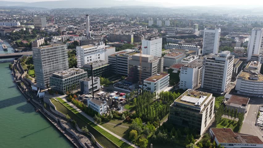 The Novartis Campus in Basel, Switzerland, focusing on life sciences, pharmaceutical innovation, and corporate architecture, aerial drone video.