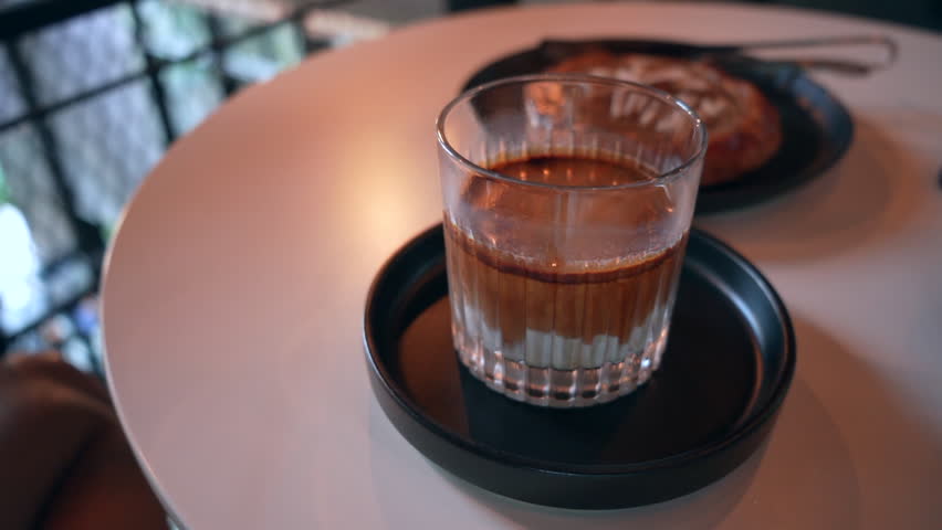 Dirty Coffee Double Shot on White Table in Modern Cafe 4K