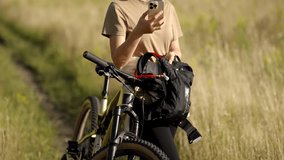 Cyclist Taking Break From Biking On  Trail. Holding Smartphone For Navigation. Mountain Biker Resting. Modern Active Living. Outdoor Activity And Healthy Lifestyle. Sports Technology And Recreation  - Powered by Shutterstock - Get 15% off with code: PIKWIZARD15