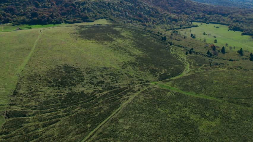 Aerial view of lush Puy de Dôme, scenic volcano near Clermont-Ferrand
