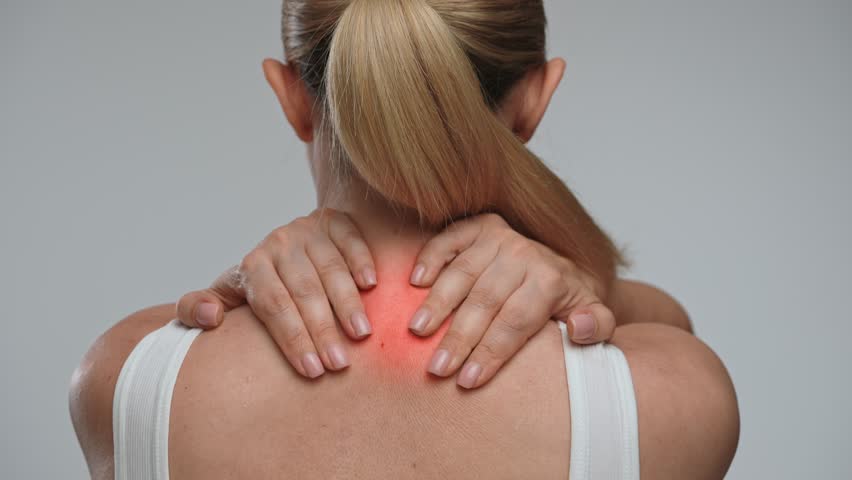 A woman with highlighted neck area indicating pain, suggesting discomfort or an injury in that region. Concept of health, treatment and pain relief. Back view.