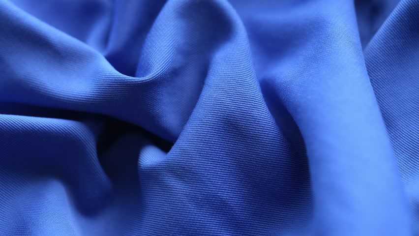 A blue wrinkled fabric texture background. Close up.