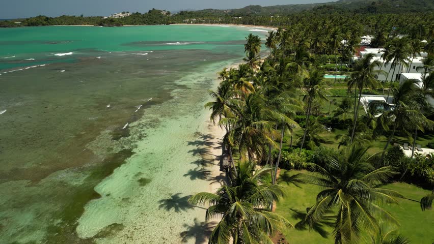 Aerial 4K view of Playa Bonita’s scenic coast, calm turquoise water, and tropical greenery. Great for vacation and resort promotion
