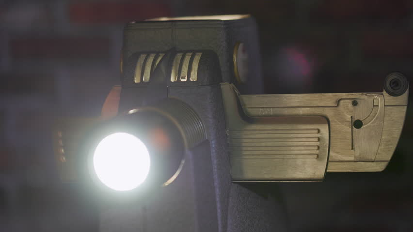 An old slide projector into which a slide is being placed.