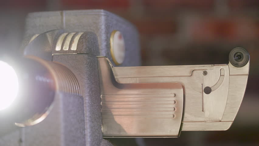 A slide being placed into an old slide projector.