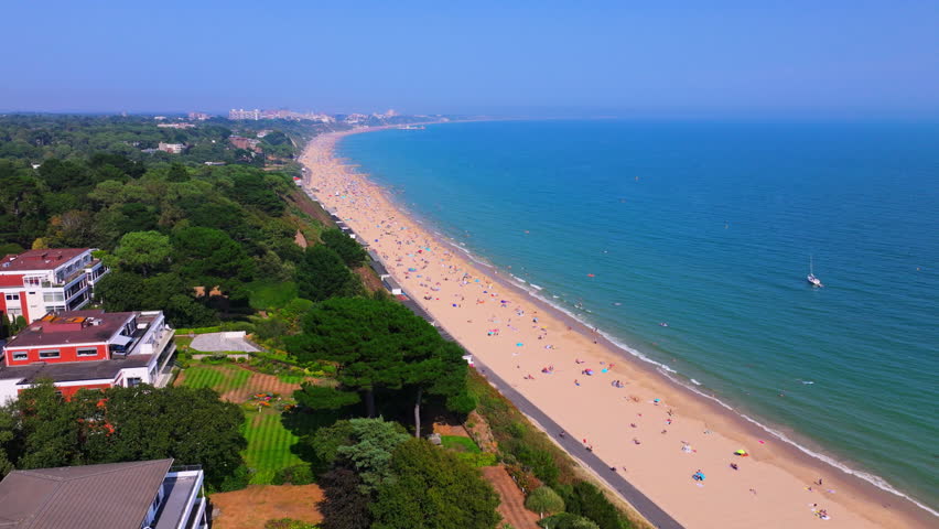 Ascending aerial shot of Bournemouth Beach and south coastline of Dorset