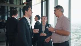 Multiracial Group of Business Professionals Standing on Rooftop Skyscraper, Engaging in Friendly Conversation and Shaking Hands Together While Networking with City Skyline View - Powered by Shutterstock - Get 15% off with code: PIKWIZARD15