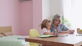 Grandmother helping granddaughter drawing, slow motion montage - Powered by Shutterstock - Get 15% off with code: PIKWIZARD15