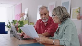 Senior couple discussing documents at home in slow motion - Powered by Shutterstock - Get 15% off with code: PIKWIZARD15