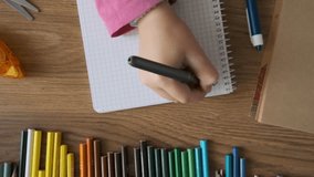 Top view of child doing math exercises in notebook with stationery on wooden table. Girl hand writing mathematical equations as school homework. Back to school, learning, education concept - Powered by Shutterstock - Get 15% off with code: PIKWIZARD15