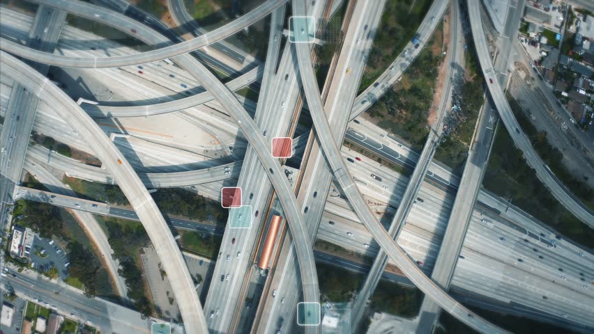 Top-down aerial of a complex highway interchange. This futuristic concept visualizes an AI surveillance system tracking vehicles with data overlays, showing the future of smart traffic management. - Powered by Shutterstock - Get 15% off with code: PIKWIZARD15