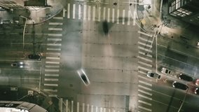 A top-down aerial of a city intersection at night with a futuristic HUD. This high-tech concept shows AI surveillance tracking individual cars with data, visualizing smart traffic management. - Powered by Shutterstock - Get 15% off with code: PIKWIZARD15