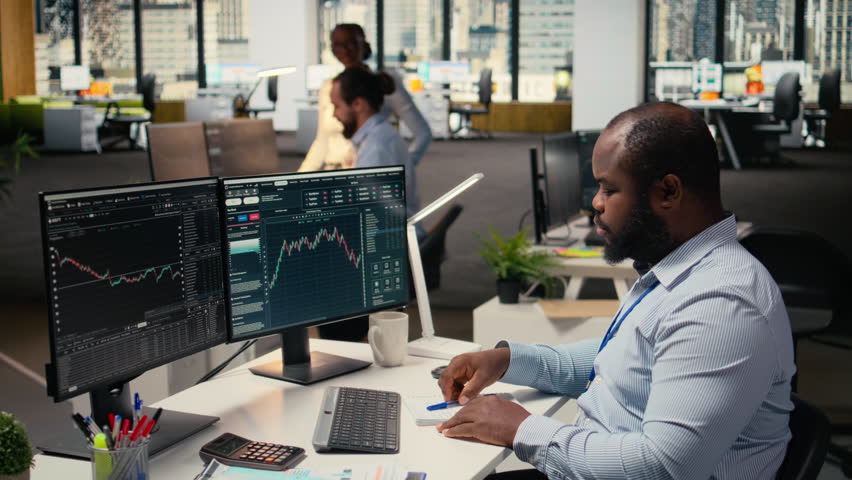 Anxious portfolio manager worried by negative investment returns. Upset African american man distressed by low performance metrics, failing to capitalize on investment fluctuations, camera A