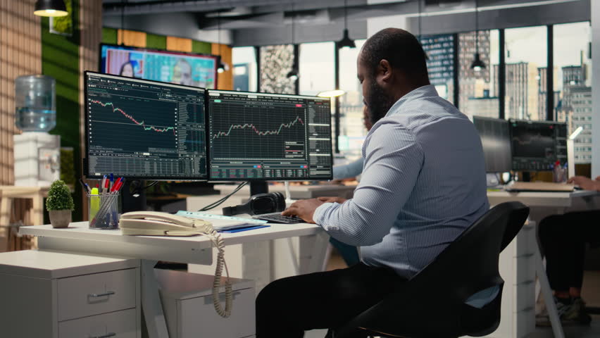 Worried portfolio managers making telephone calls in response to Black Swan event disruption. Panicked prop firm workers evaluate stock market impact of unexpected recession, camera A