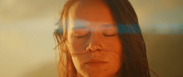 Close-up of woman with eyes closed in serene outdoor lighting - Powered by Shutterstock - Get 15% off with code: PIKWIZARD15