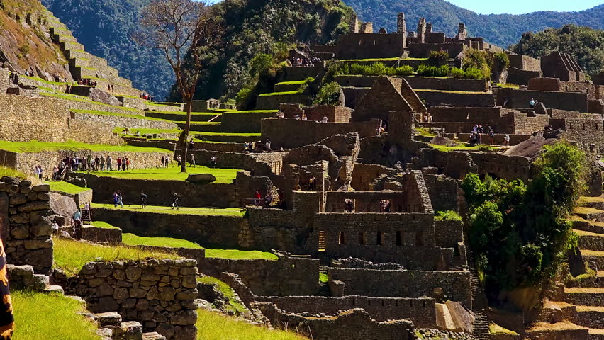 Experience the breathtaking grandeur of Machu Picchu with this stunning pan shot. Explore the ancient Inca ruins, terraced mountains, and dramatic Andes landscape in Peru.