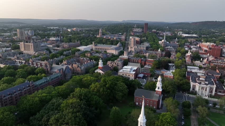 Historic city of New Haven with churches, famous Yale university in gothic architecture and downtown. Dusk scene after sunset. Drone wide shot. Connecticut , USA.