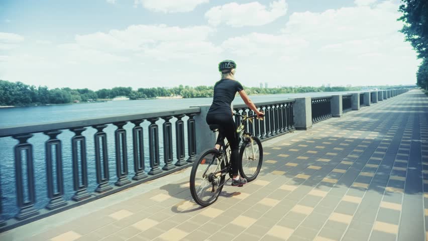 Woman Riding Bicycle. Female Cyclist With Helmet. Active Lifestyle And Urban Cycling. Training For Fitness. Cycling Exercise. Sporty Woman Cyclist Physical Activity And Recreation. Bike Ride Cyclist Fitness. Recreation Cyclist