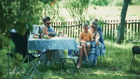 Family Enjoying Outdoor Picnic. Parents And Children. Backyard Barbecue With Family. Summer Leisure Activities. Happy Family. Summer Party Children With Parents At Picnic. Happy Moment Family Bonding - Powered by Shutterstock - Get 15% off with code: PIKWIZARD15