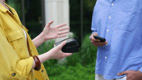 A person using a smartphone to pay with a contactless payment system at a shop using a POS terminal. - Powered by Shutterstock - Get 15% off with code: PIKWIZARD15