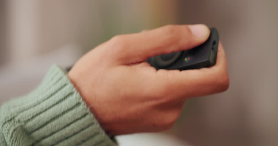 Home, hand and person with remote control, watching tv and subscription with channel surfing. Closeup, apartment and click with movie, streaming service and film with series and entertainment